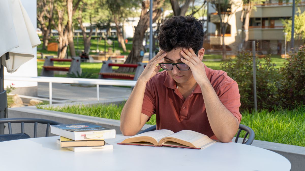 confused businessman reading exam requirement letter
