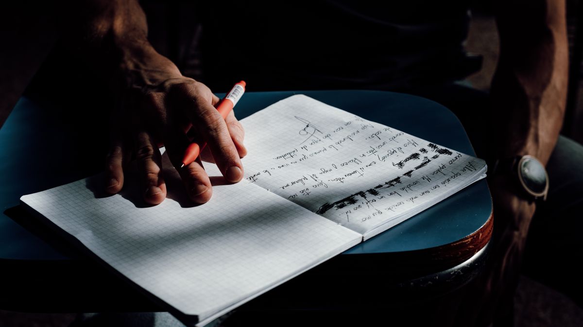 adult taking practice exam with pencil and clock