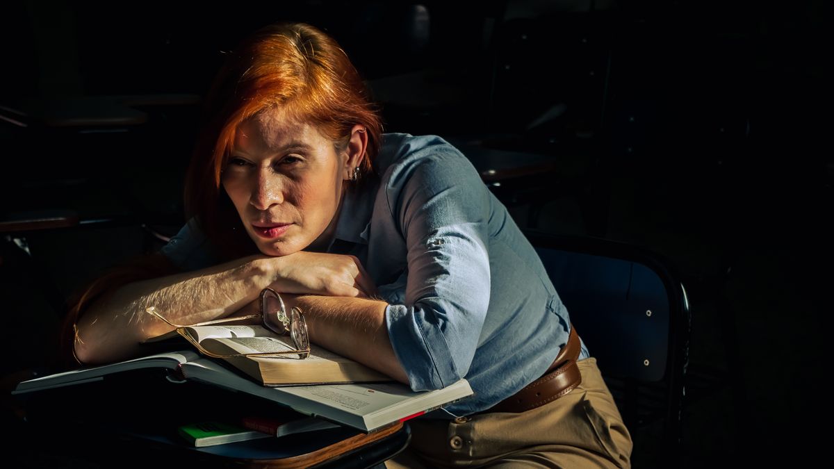 tired student studying night desk