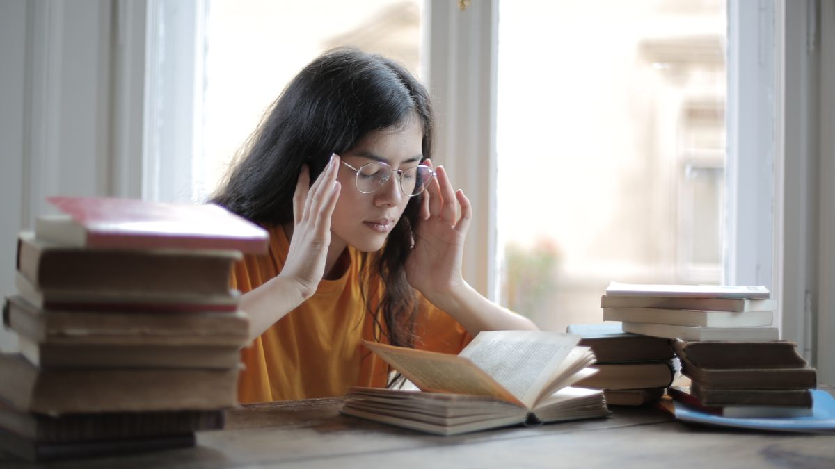 woman studying textbook desk