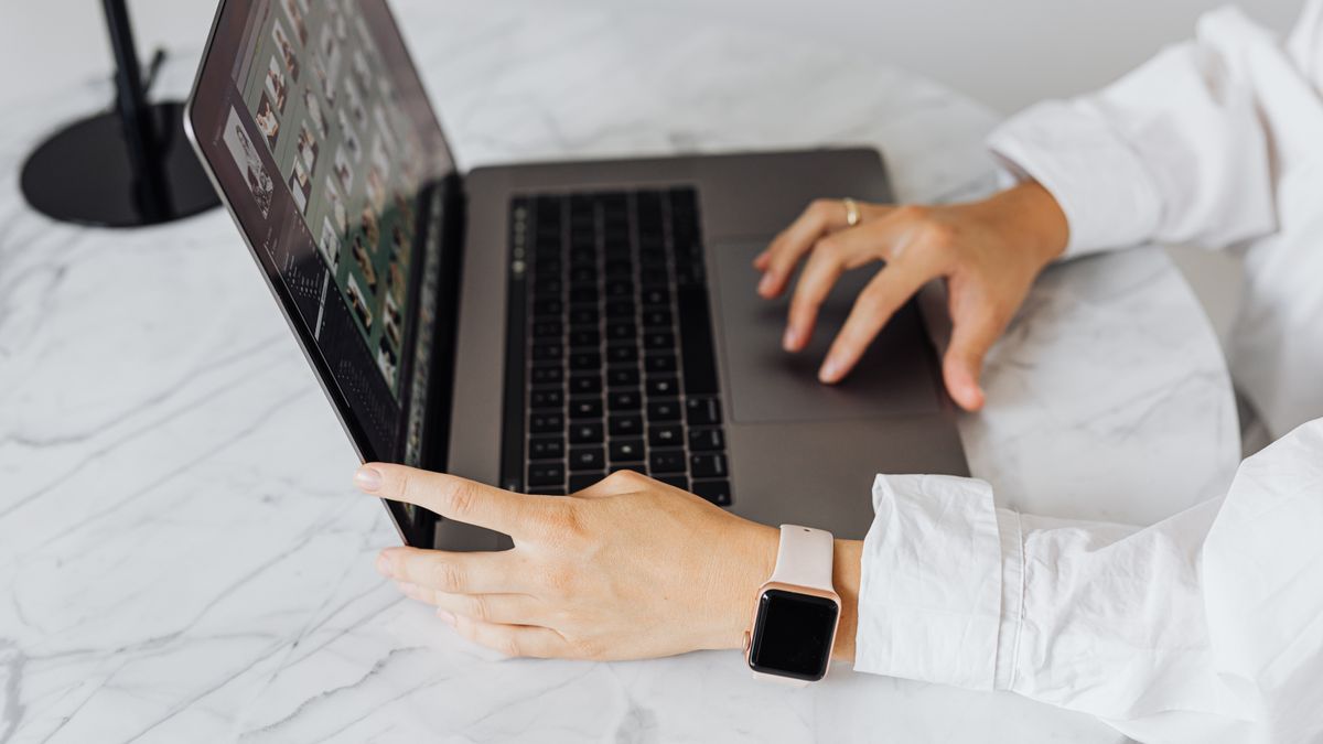 person comparing online course options on laptop desk