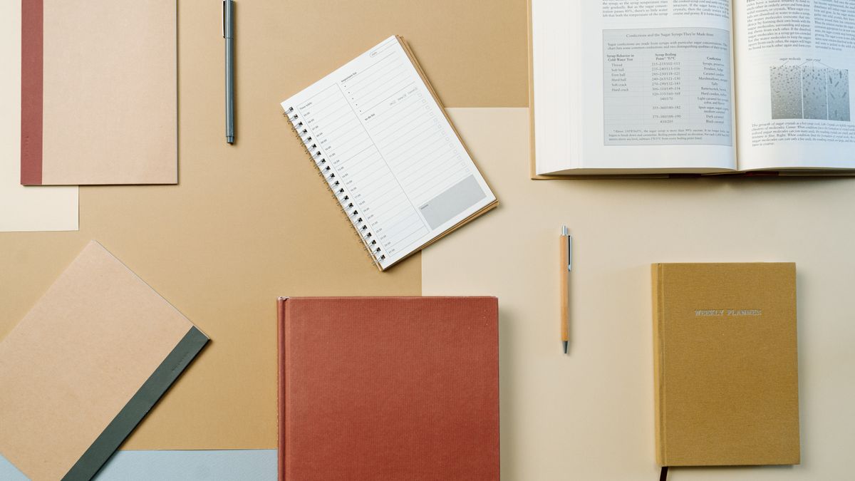 study planner, open textbook, desk