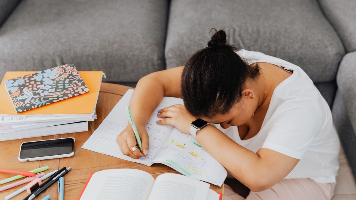 study desk with textbooks, highlighter, notebook