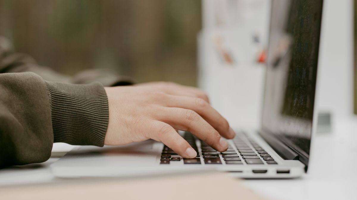 student typing sentence exercise laptop screen