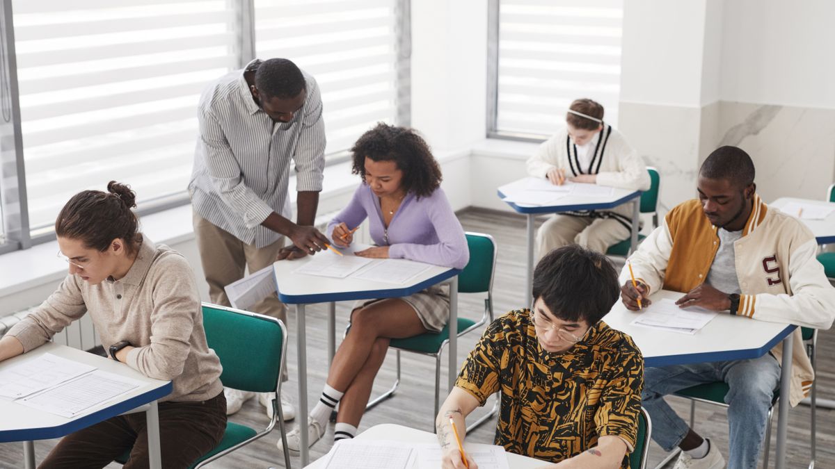 exam candidates writing test in classroom