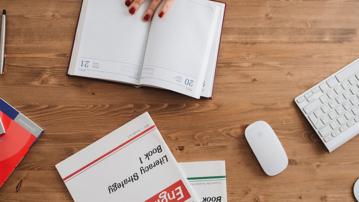 person studying english textbook desk calendar