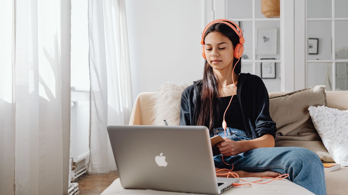 student wearing headphones taking English listening test