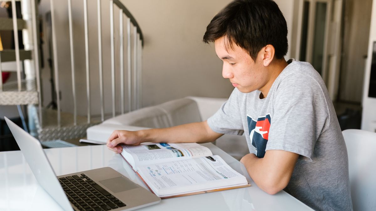 person studying building code textbook desk