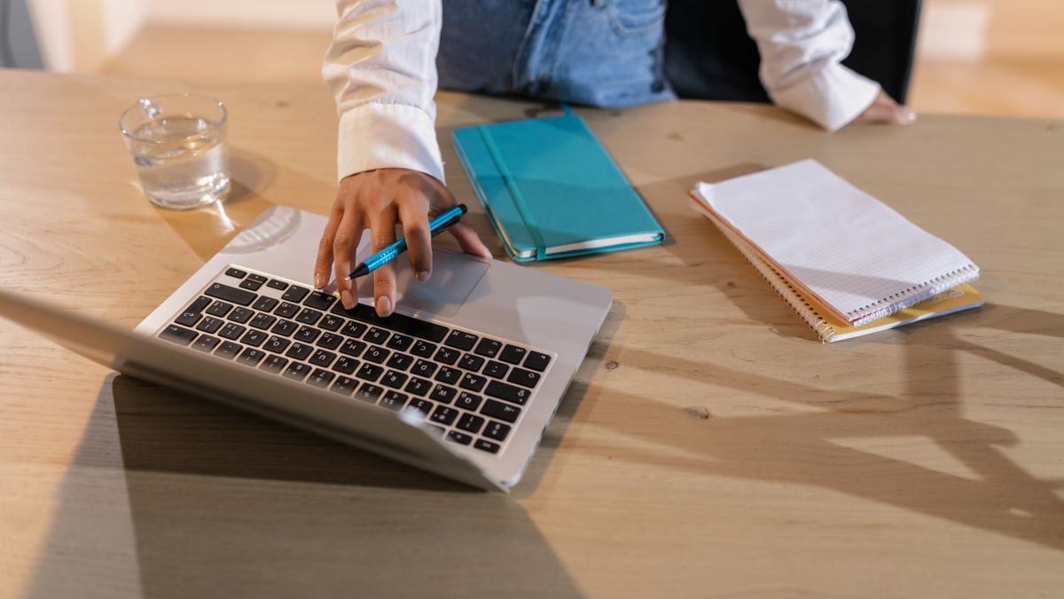person studying english online with laptop, notebook