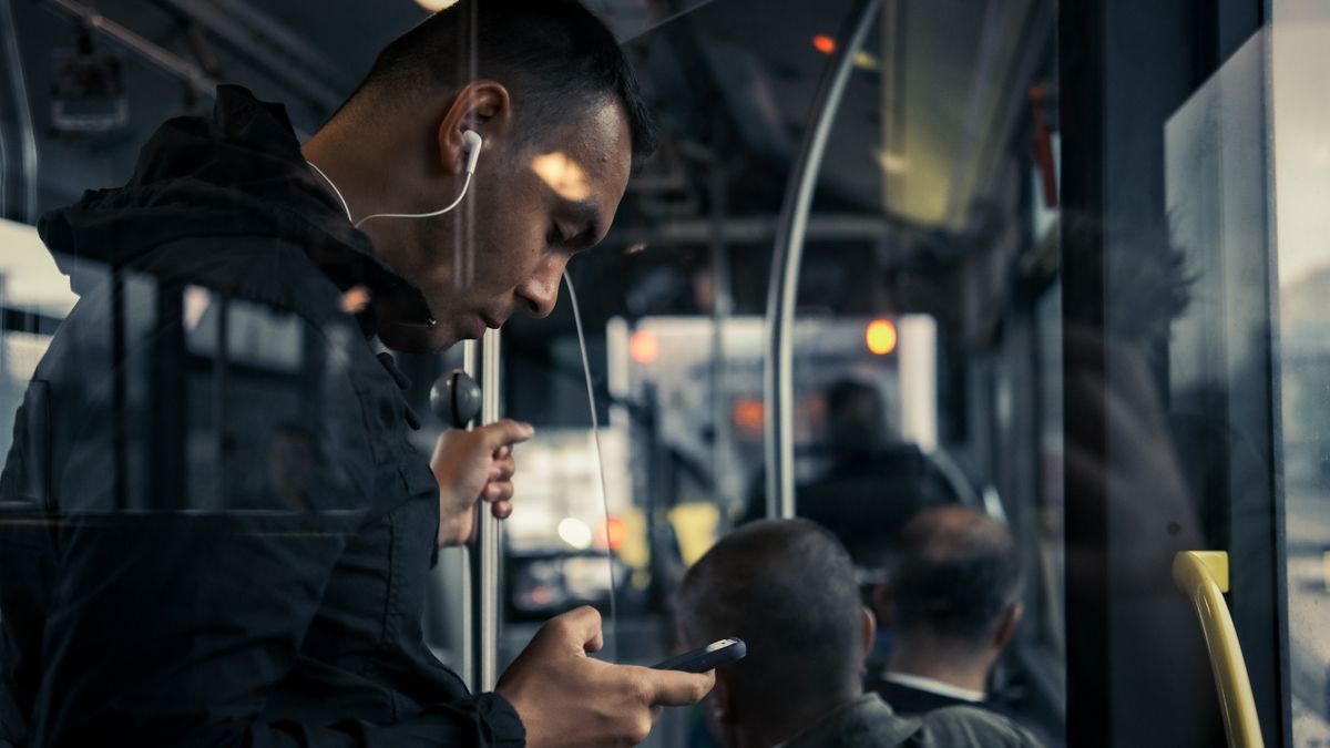 commuter train listening earphones smartphone