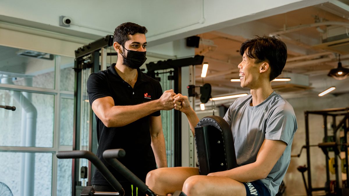 personal trainer coaching client gym