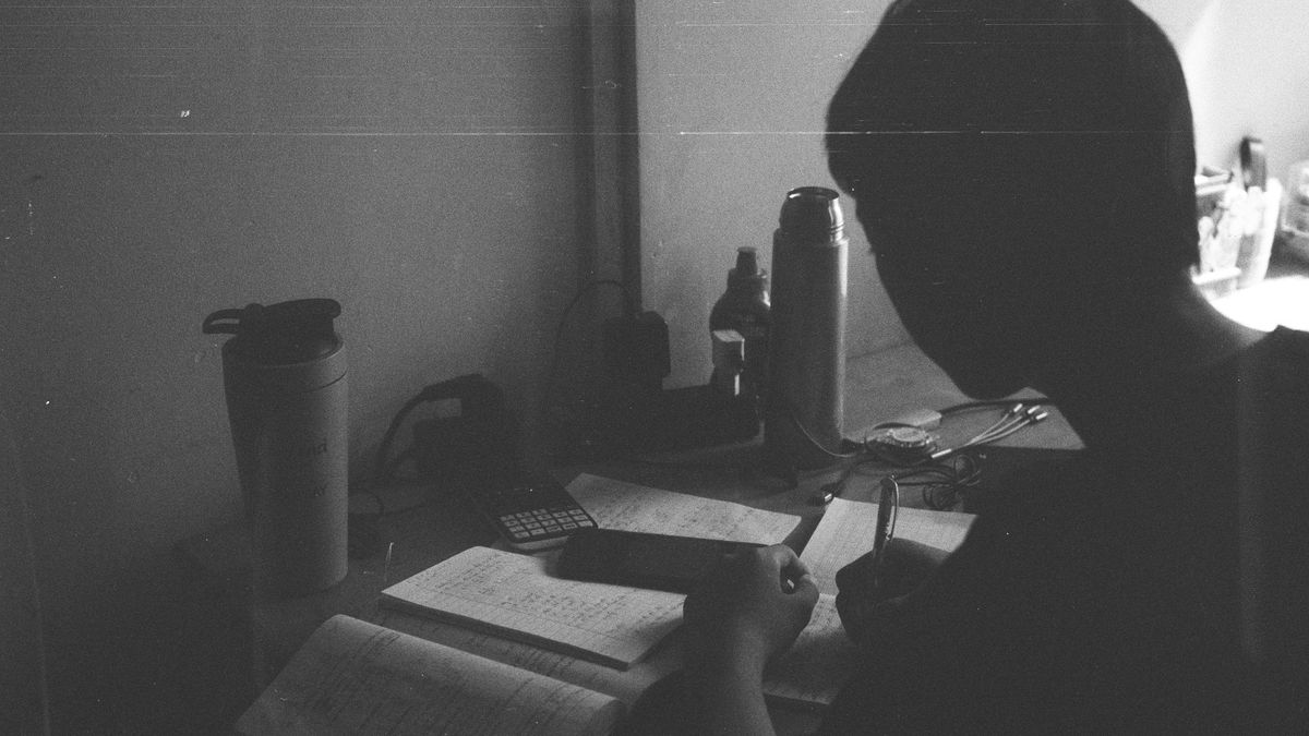 study desk with notebook and coffee at night