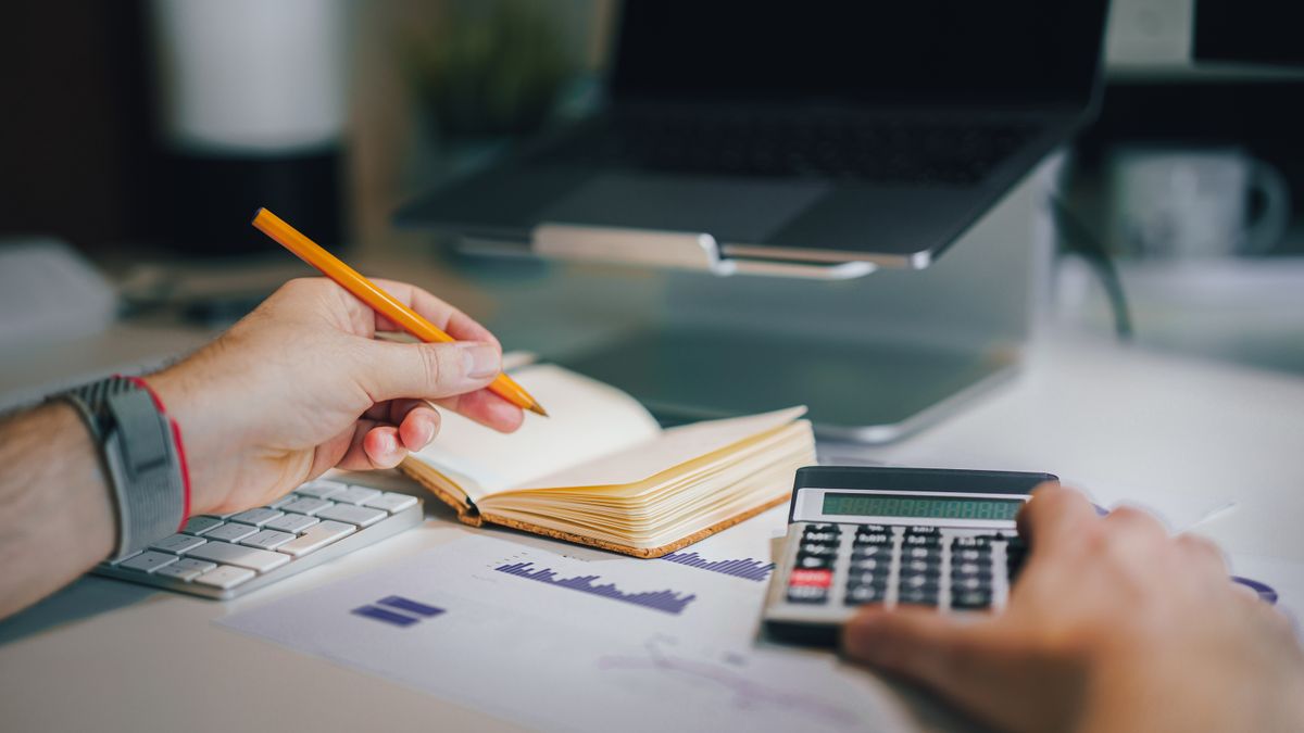 financial documents with calculator on office desk