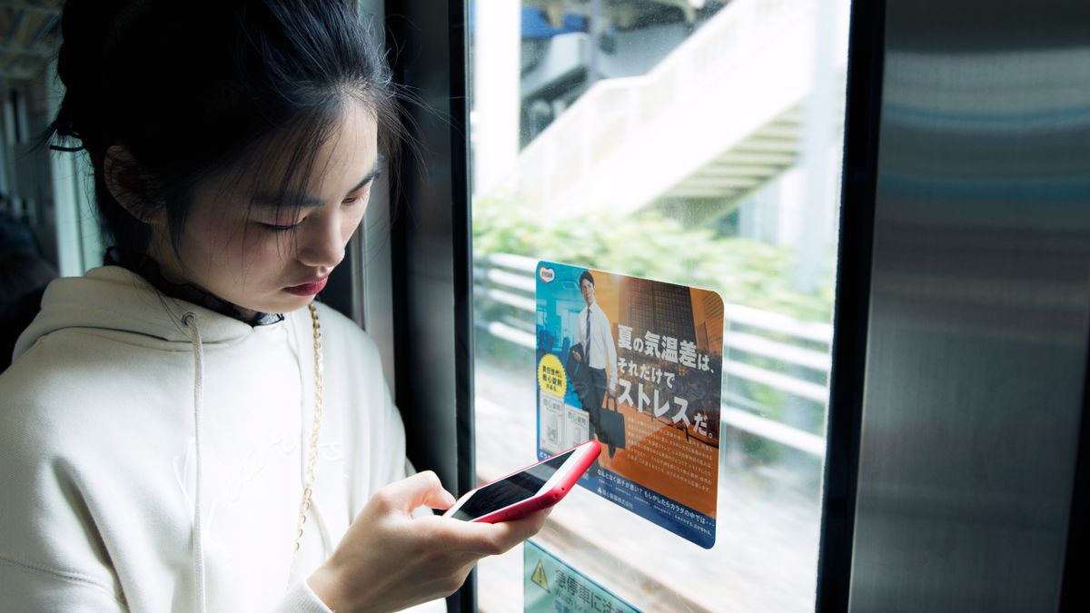 person studying on train commute smartphone