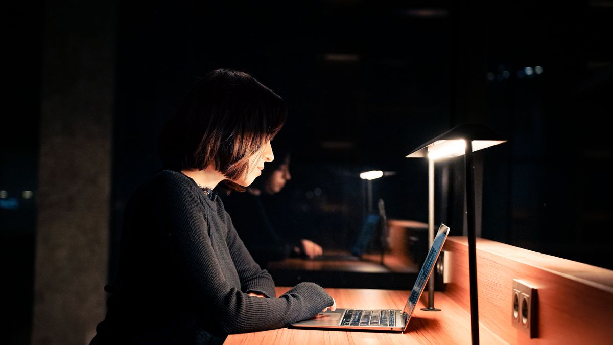 office worker studying at night with laptop