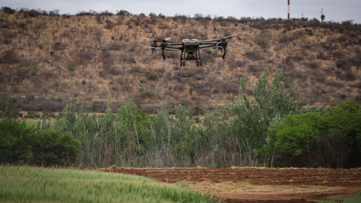 drone flying over green farm field