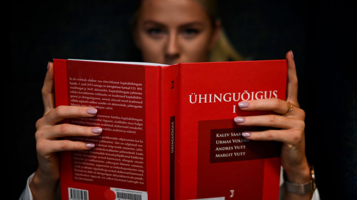 person studying law textbook at desk