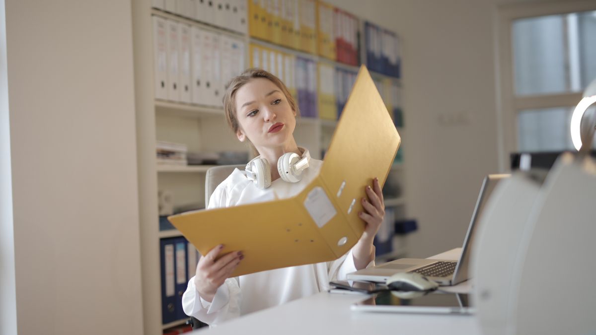 woman checking documents at desk