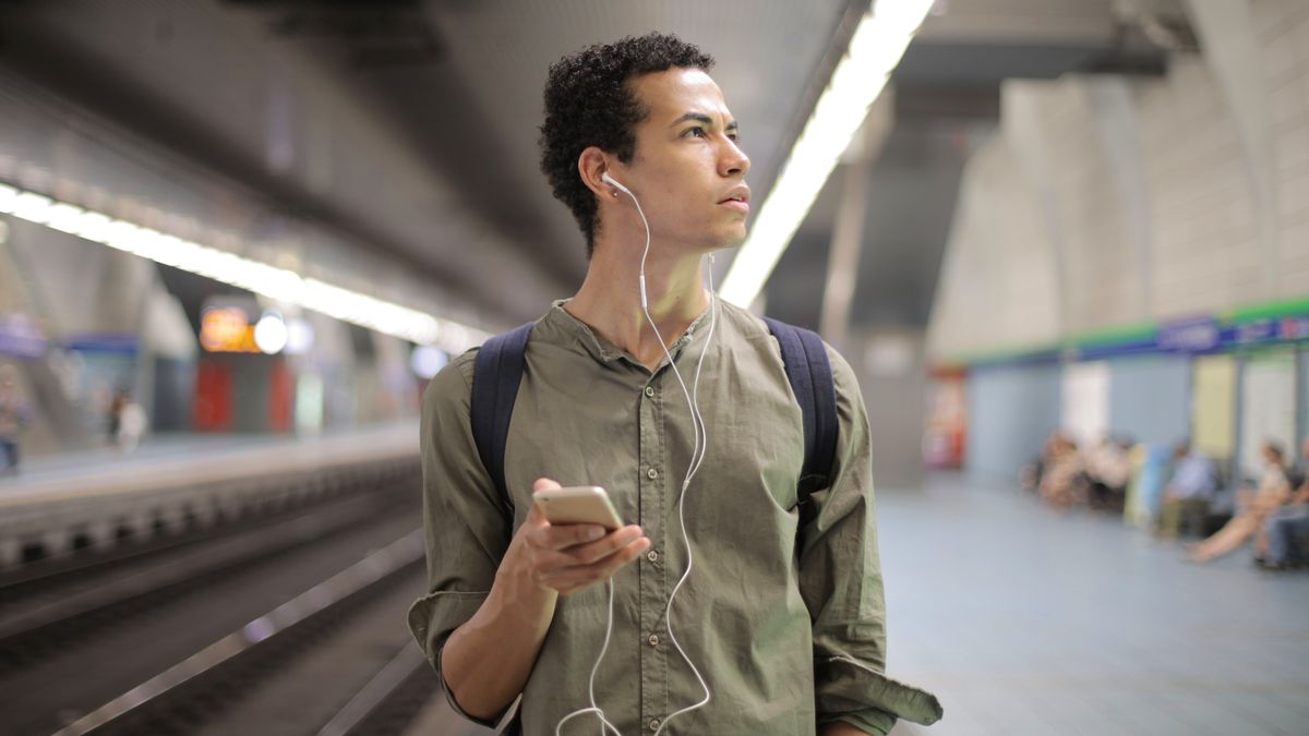 person studying smartphone commute train