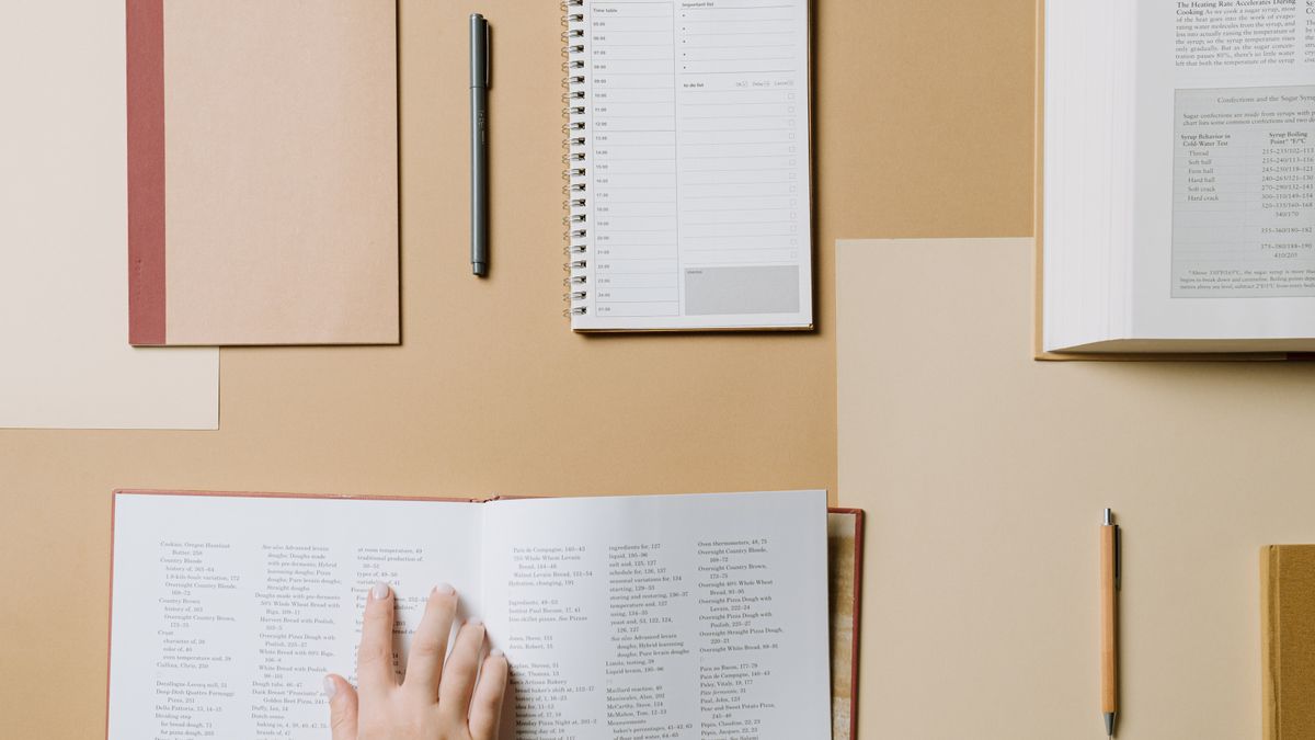 person studying with calendar and clock at desk