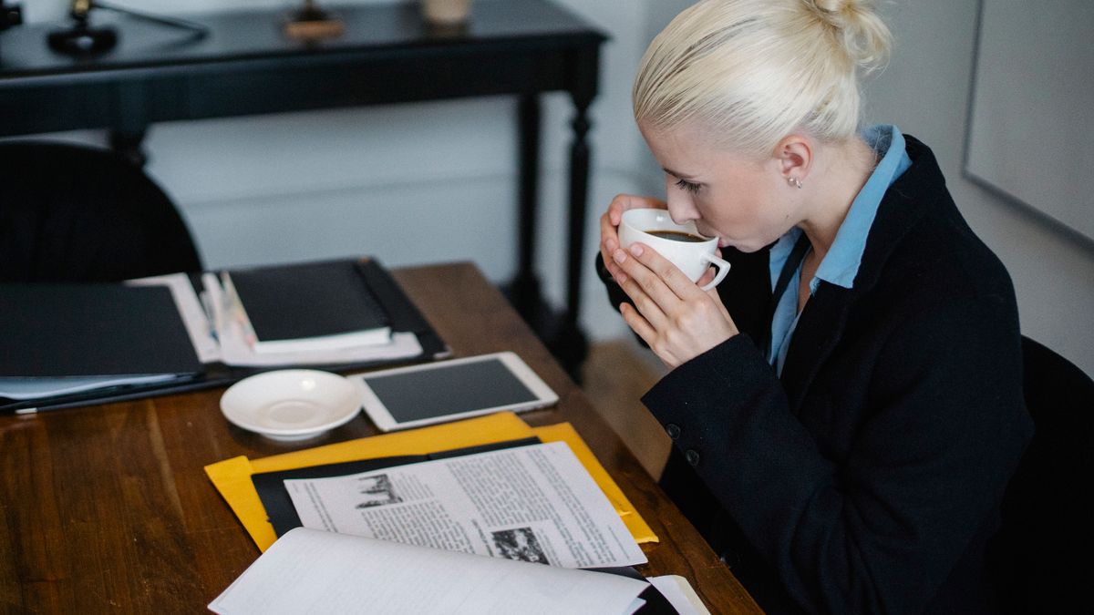 office worker studying real estate law textbook desk