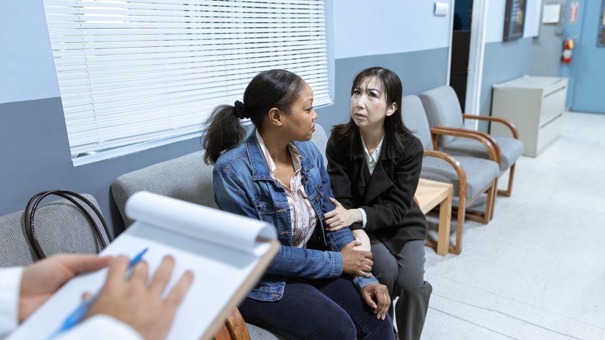 social worker counseling patient hospital room
