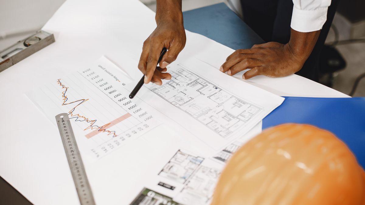 architect reviewing blueprints office