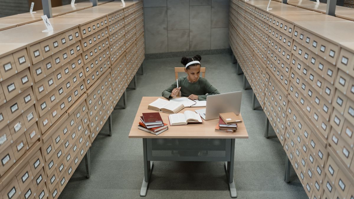 adult studying architecture textbook at desk