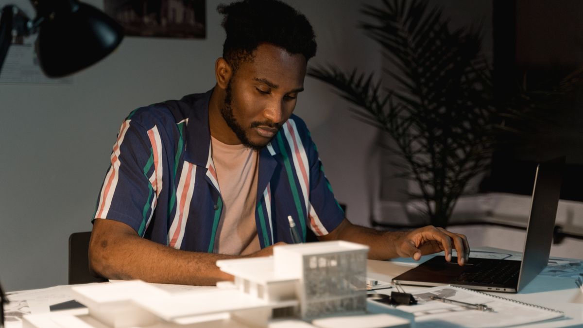 young architect studying laptop evening