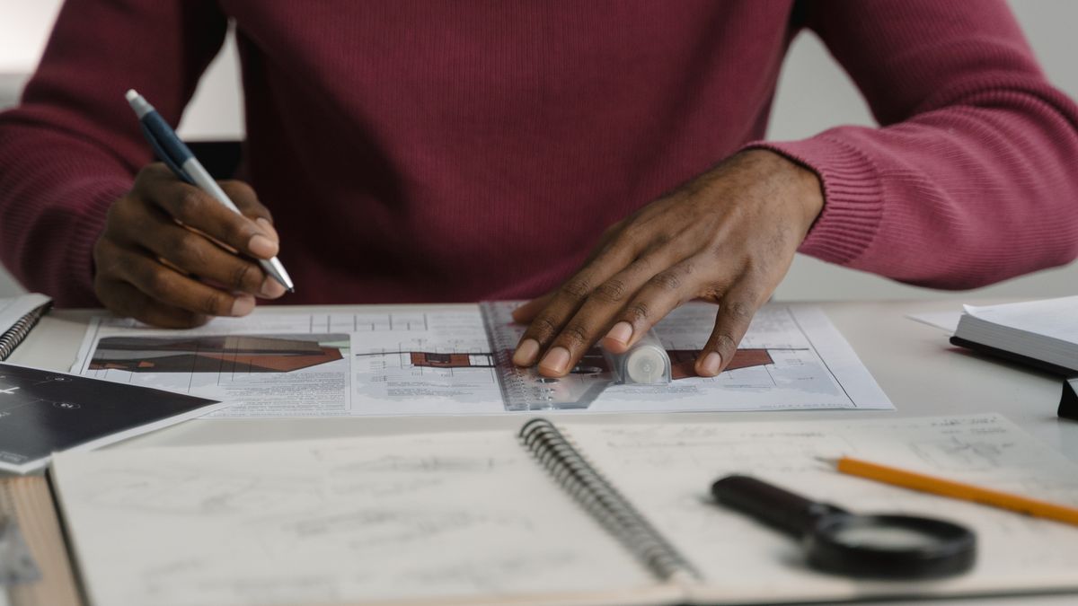 architect drafting floor plan at desk