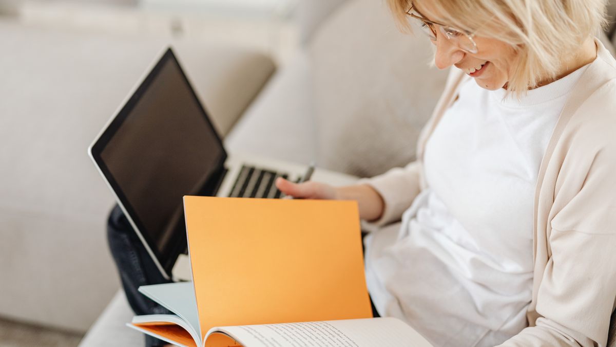 woman studying pet grooming textbook home