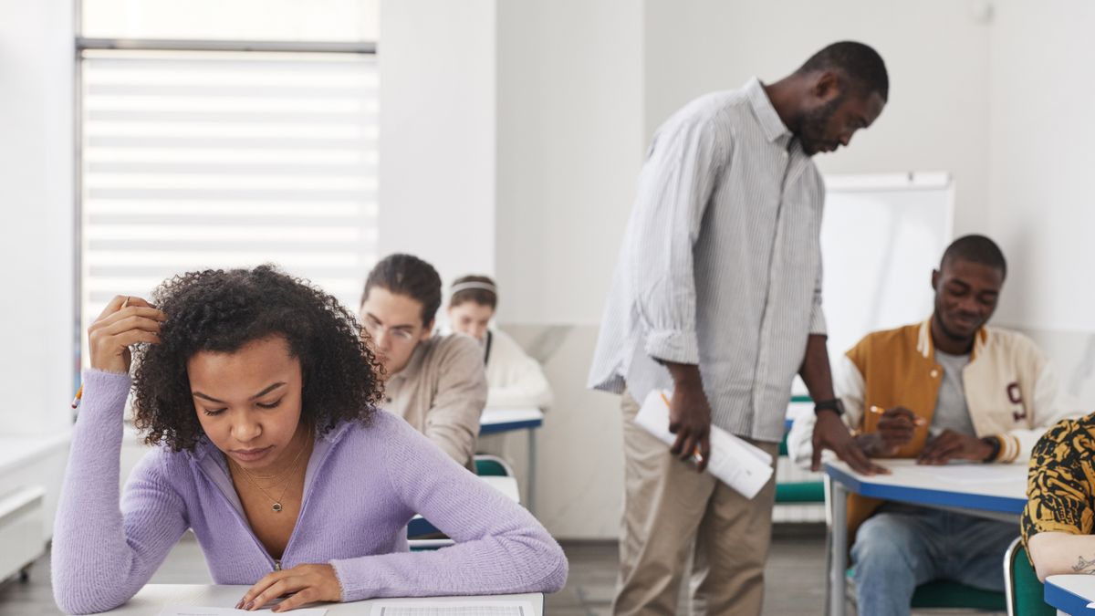 person analyzing exam past papers desk