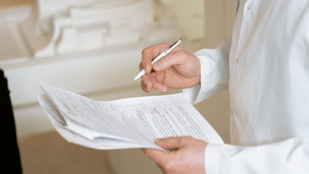 chef reviewing exam results chart in kitchen