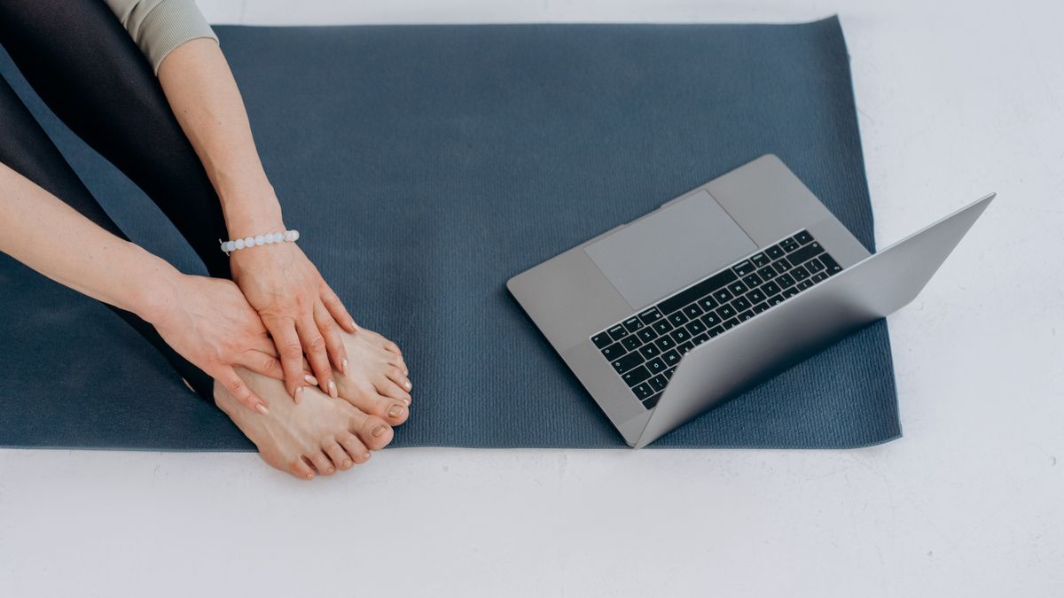 person studying yoga certification course online