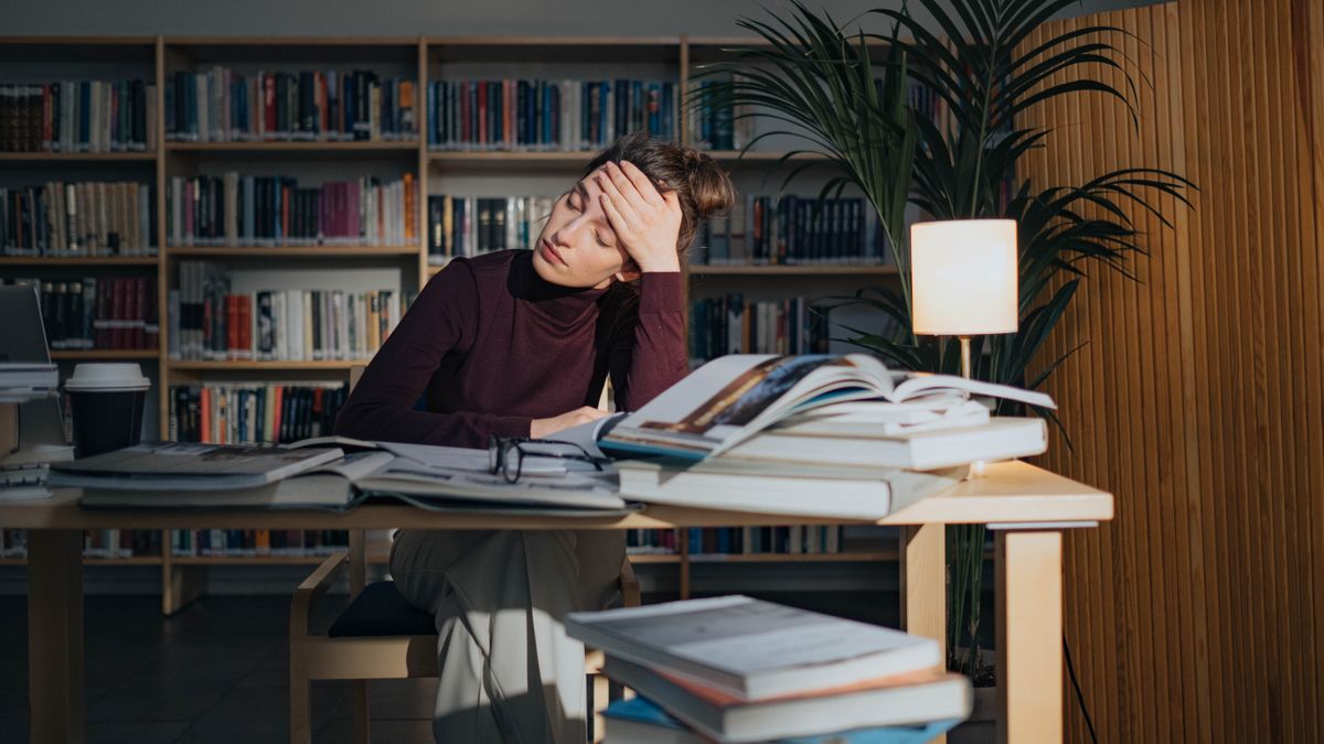 tired worker studying late night at home