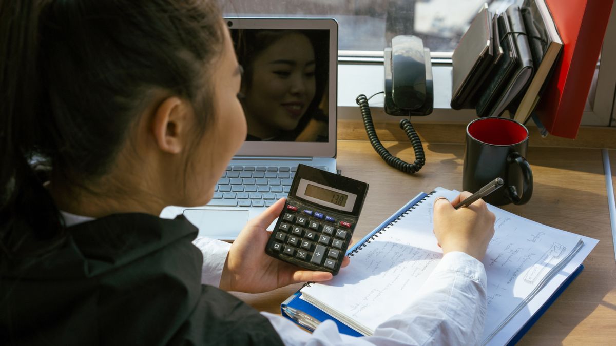 calculator with notebook on desk