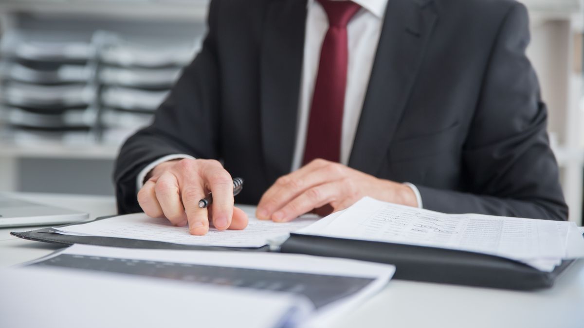 property manager reviewing rental lease documents at desk