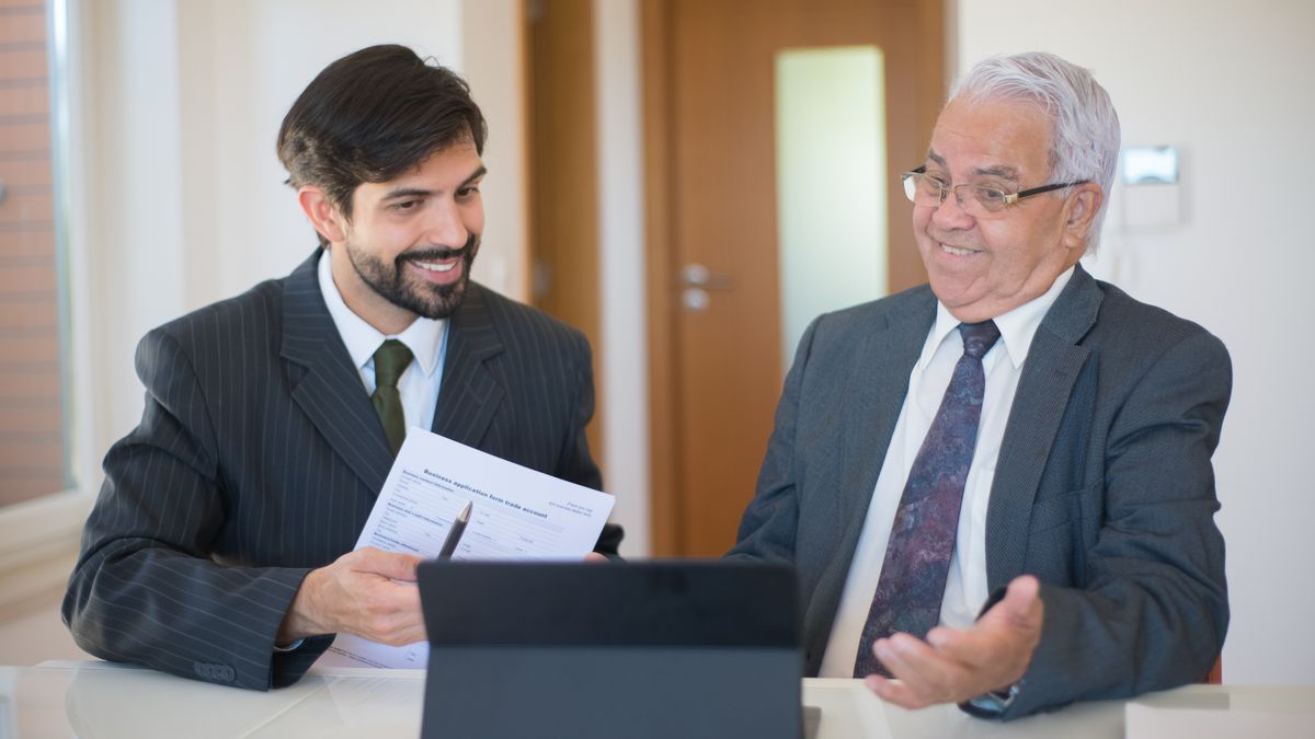 real estate agent explaining documents to client at desk