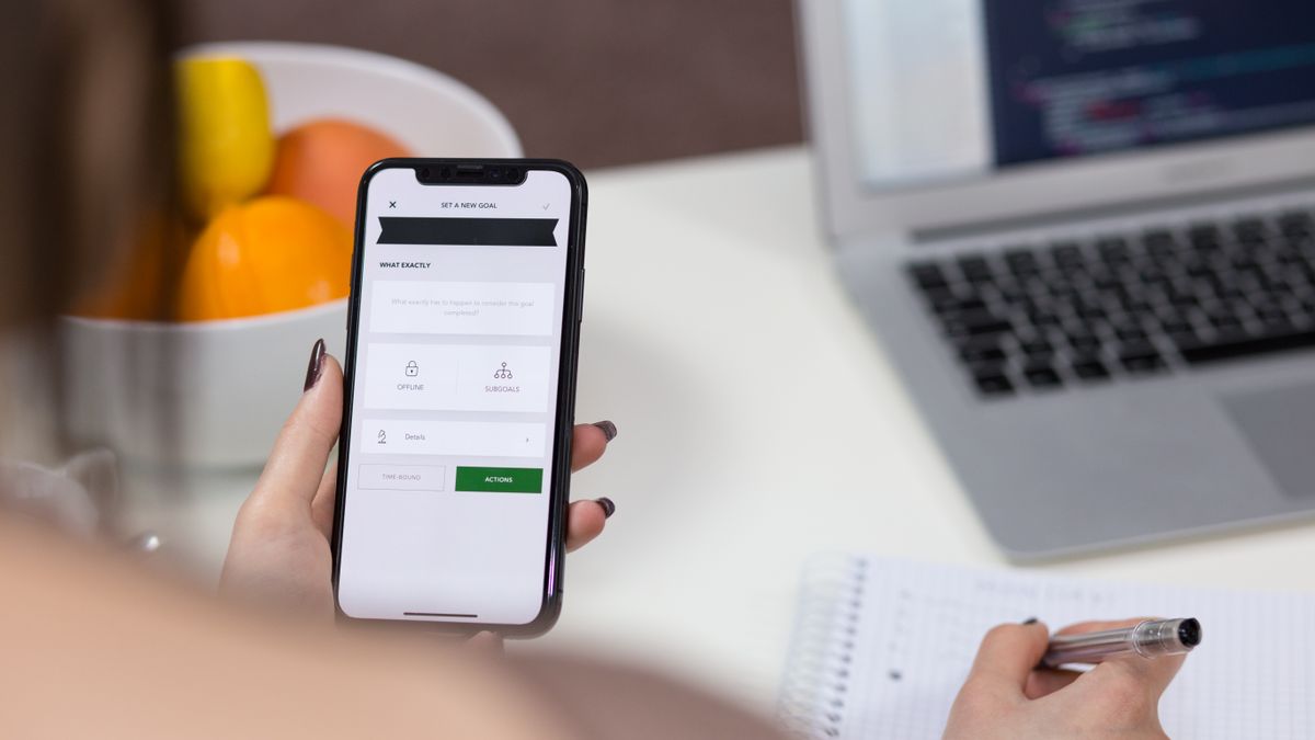 person submitting application form on laptop office
