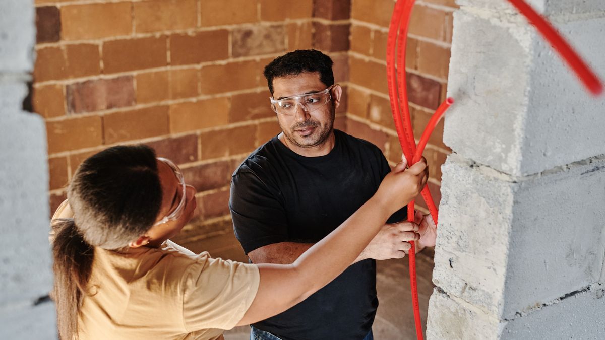 electrician installing wall outlet