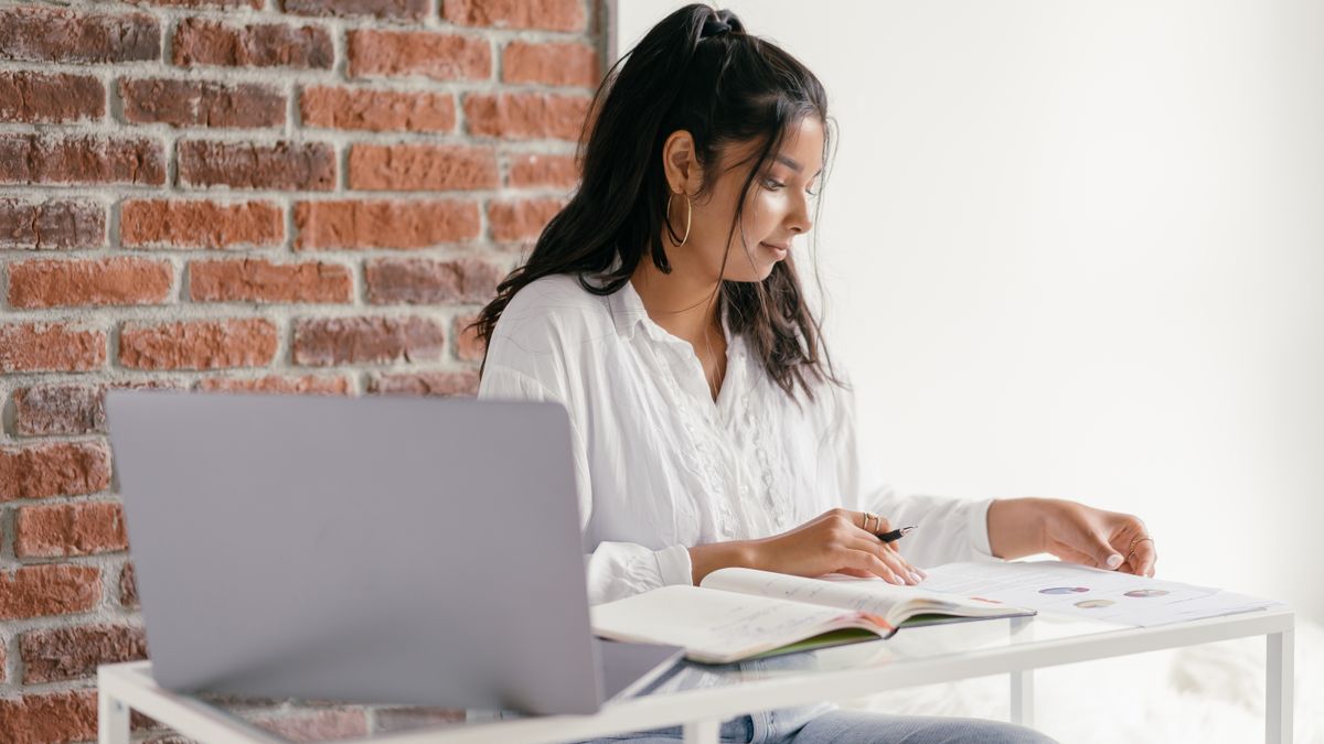 person studying kanji workbook at desk