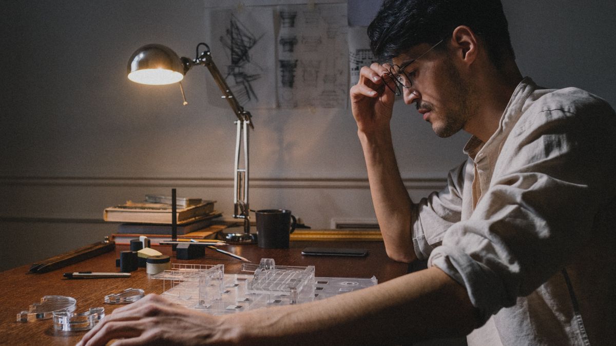 person studying electrical engineering textbook at desk in the evening