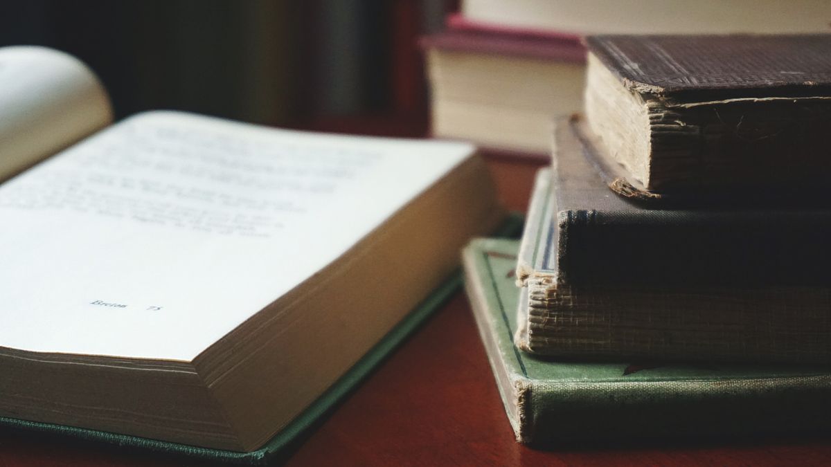 stack of study books on wooden table