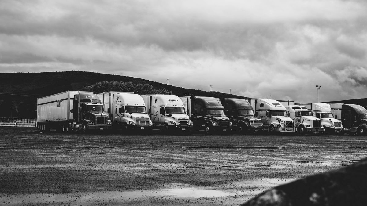 truck fleet parked at logistics depot