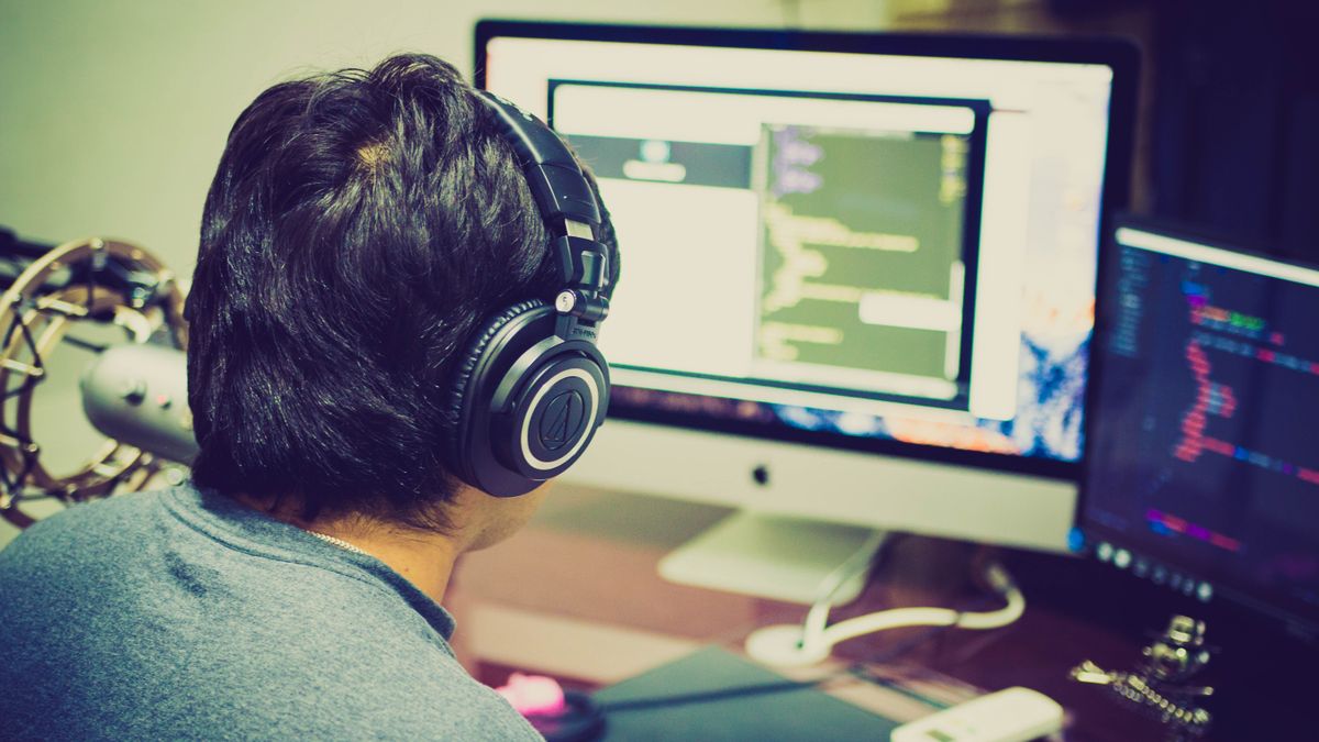 programmer reading code on monitor