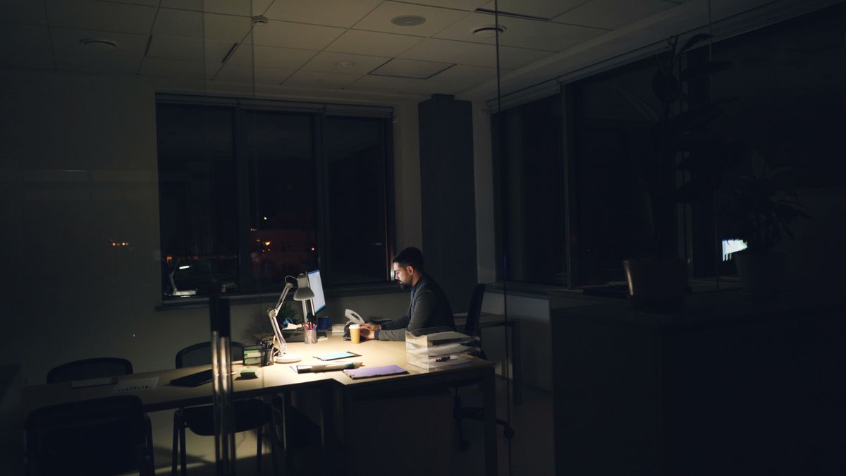office worker studying at desk at night