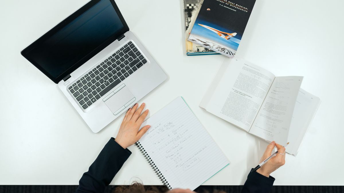 electrical engineer studying textbook at desk