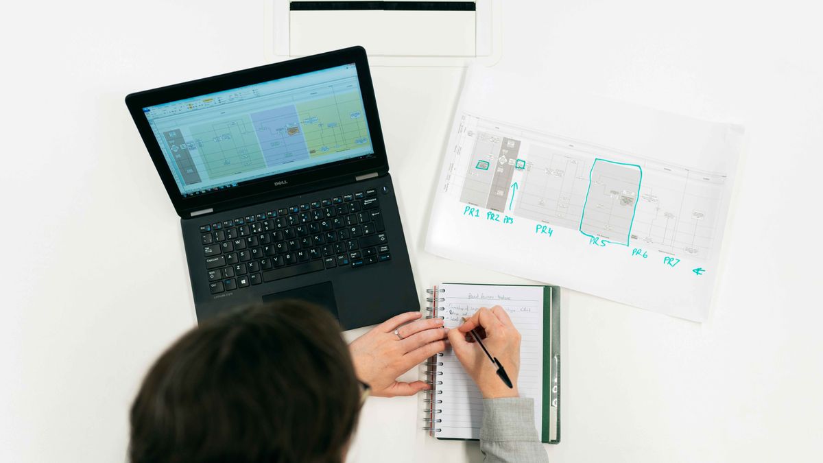 young engineer studying at desk with notebook