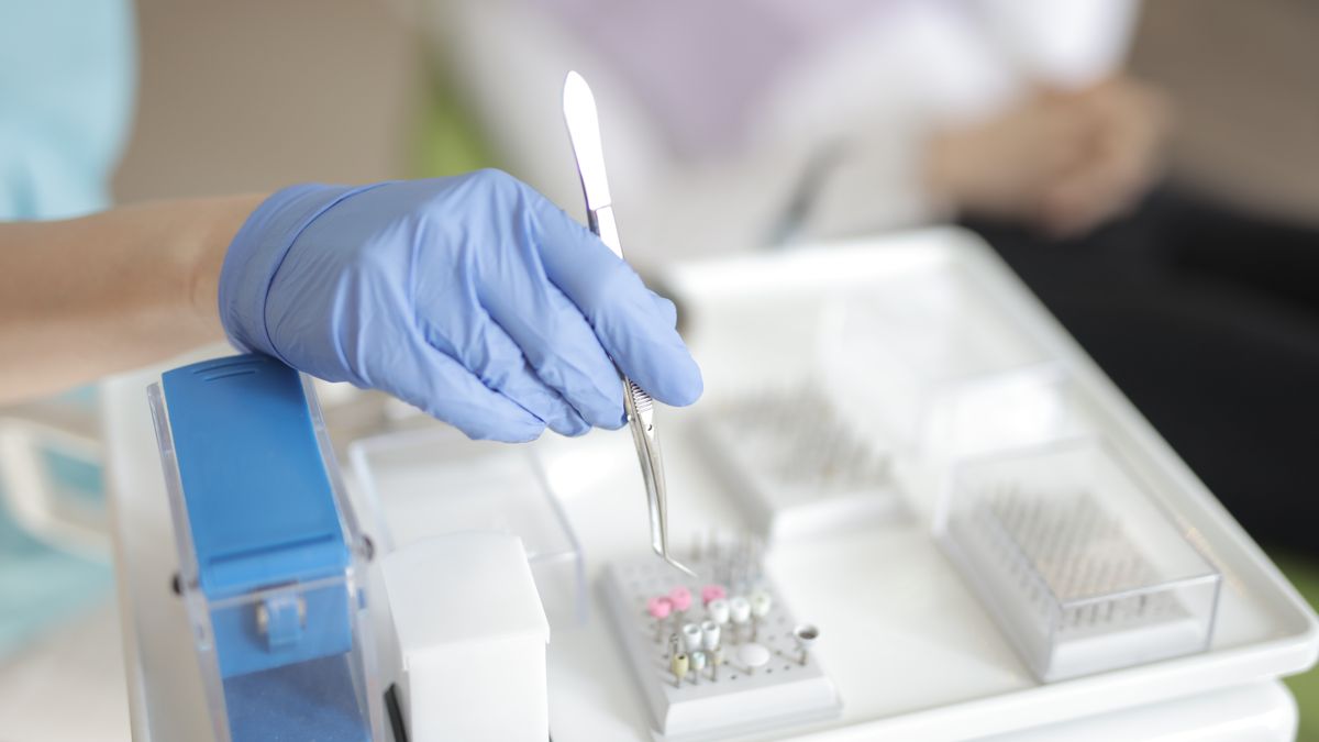 dental assistant preparing instruments in clinic