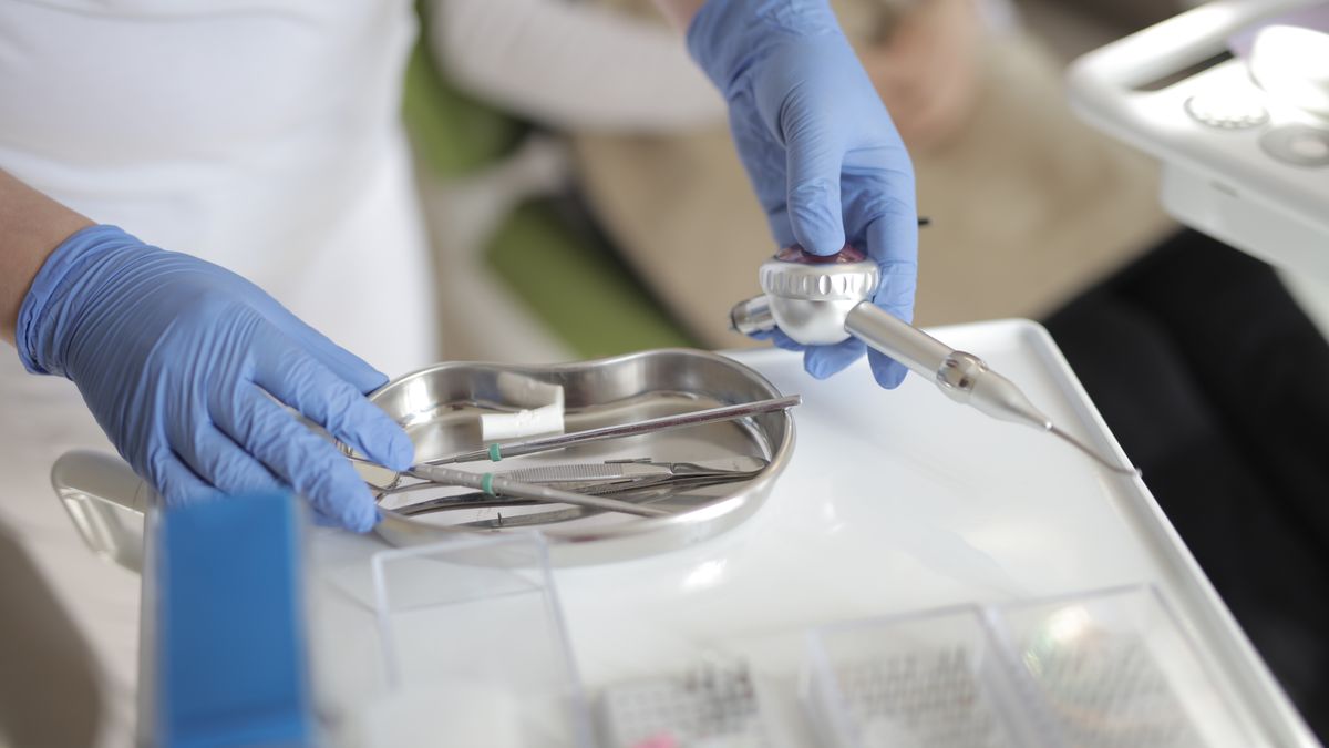 dental assistant preparing instruments in clinic